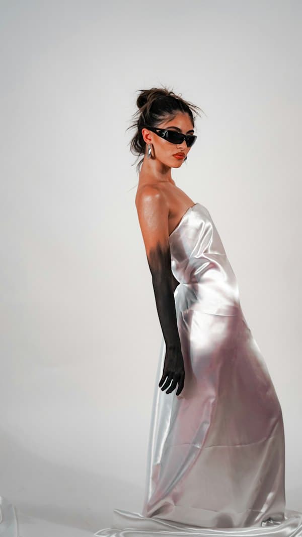 Model in a silver satin slip dress and black opera gloves
