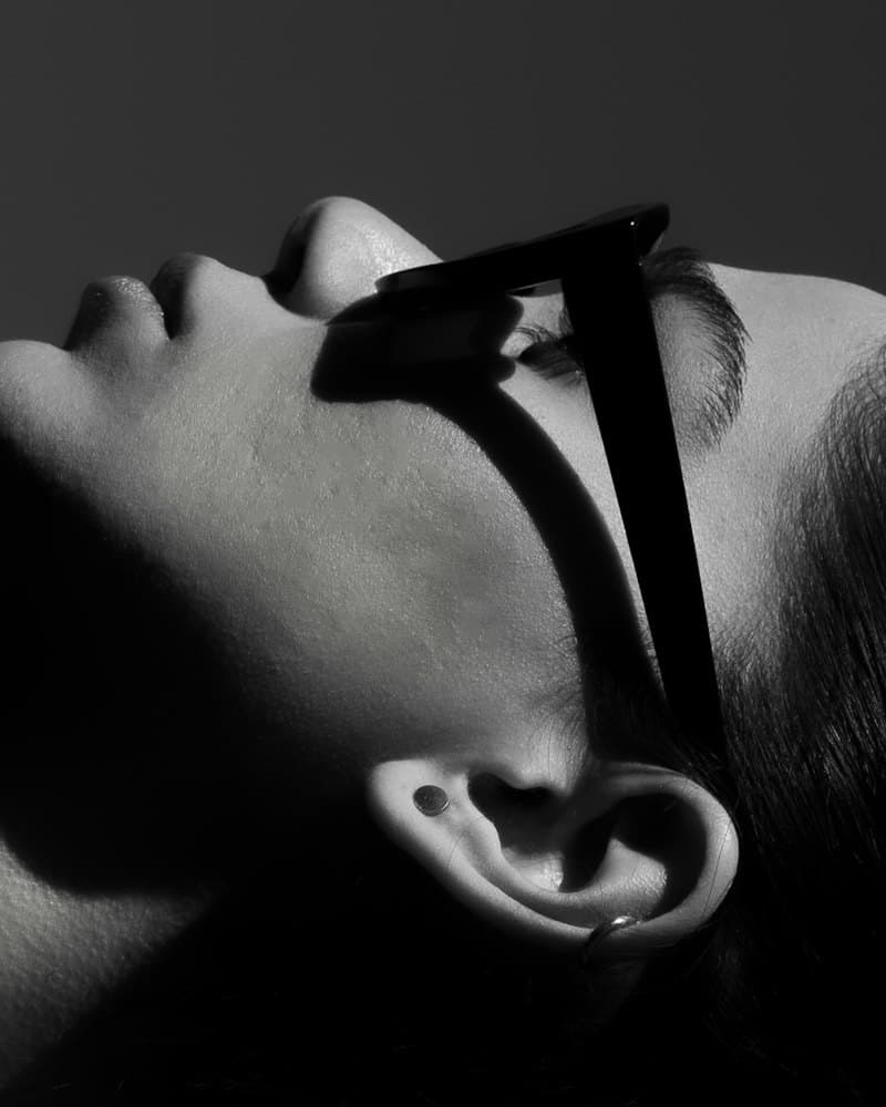 Black-and-white close-up of a profile in angular sunglasses