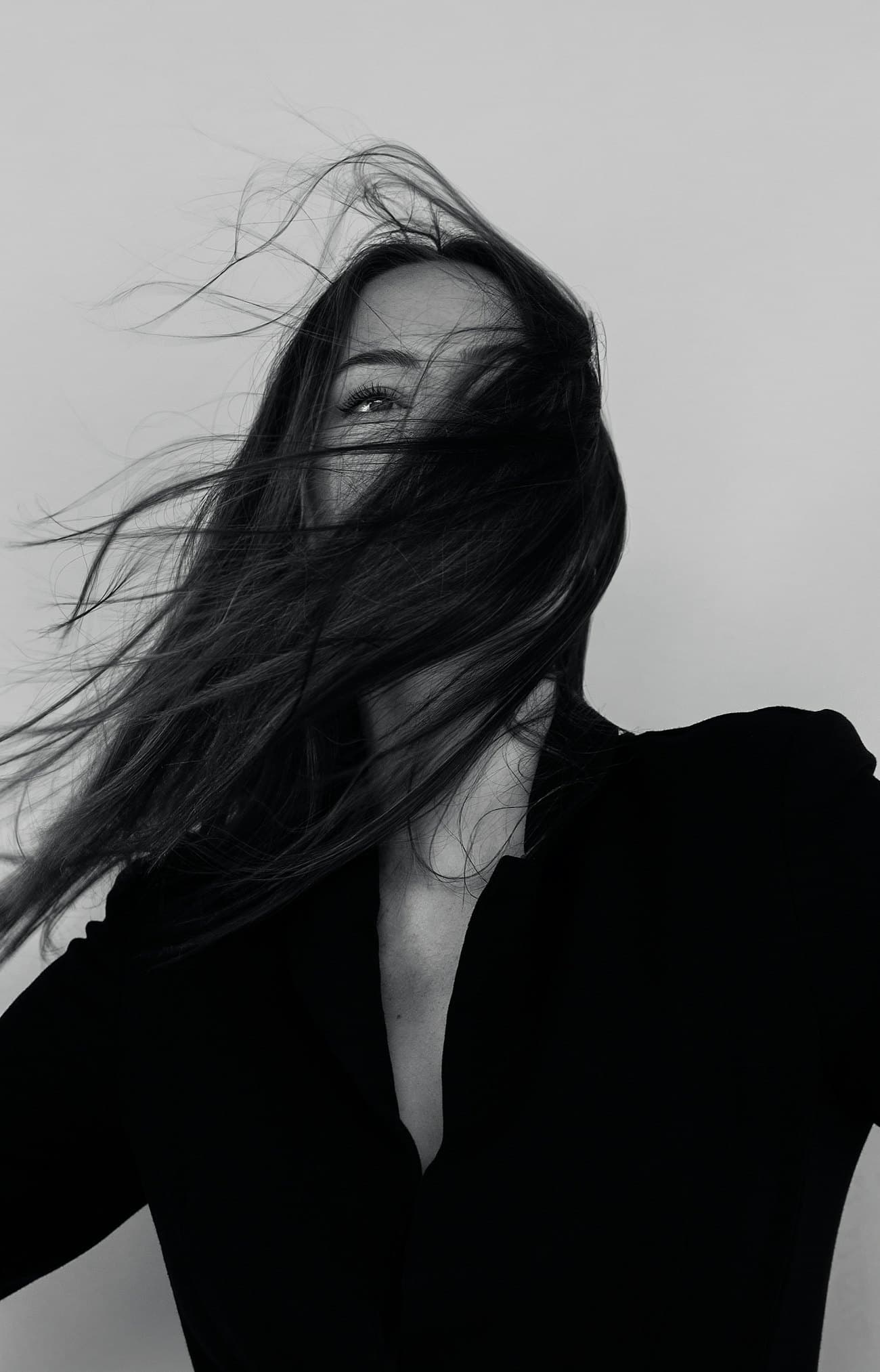 Black-and-white portrait of a model with windswept hair
